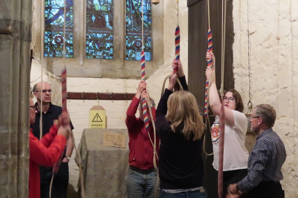 A group of people ringing bells